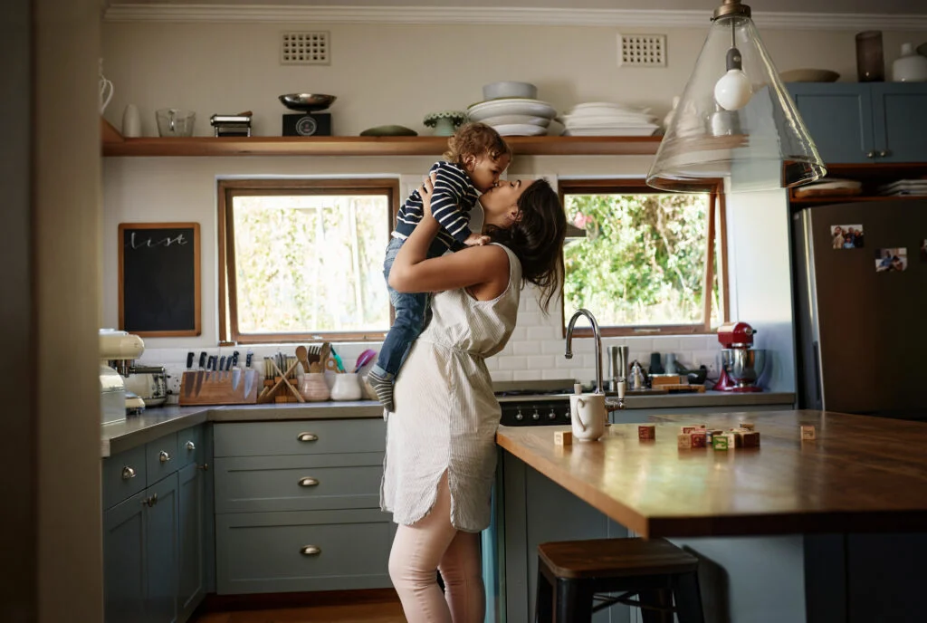 mom kissing child